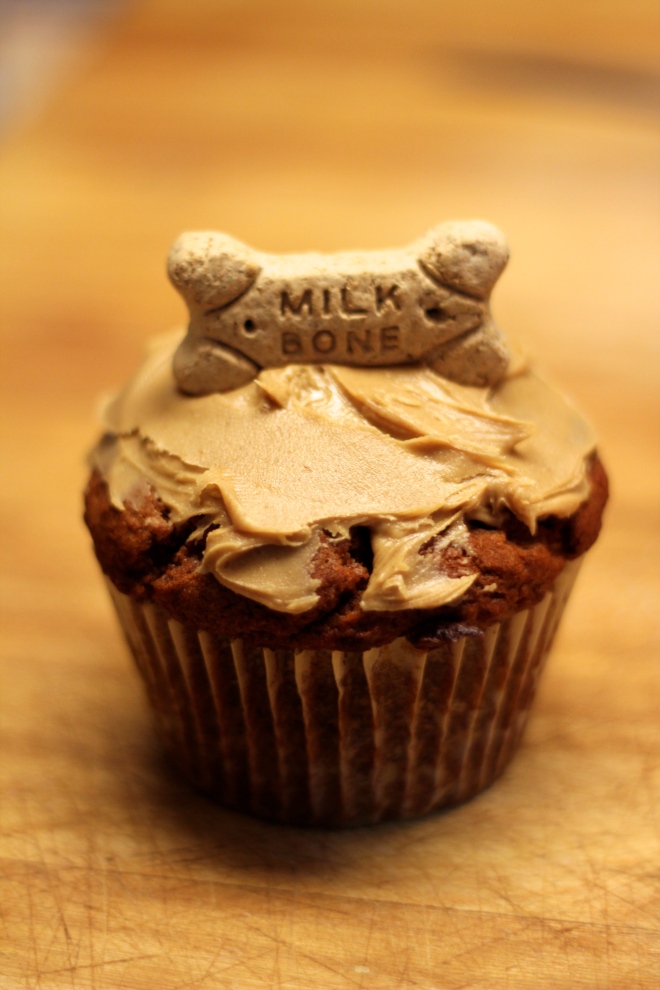 Peanut butter frosting and a milk bone decoration.